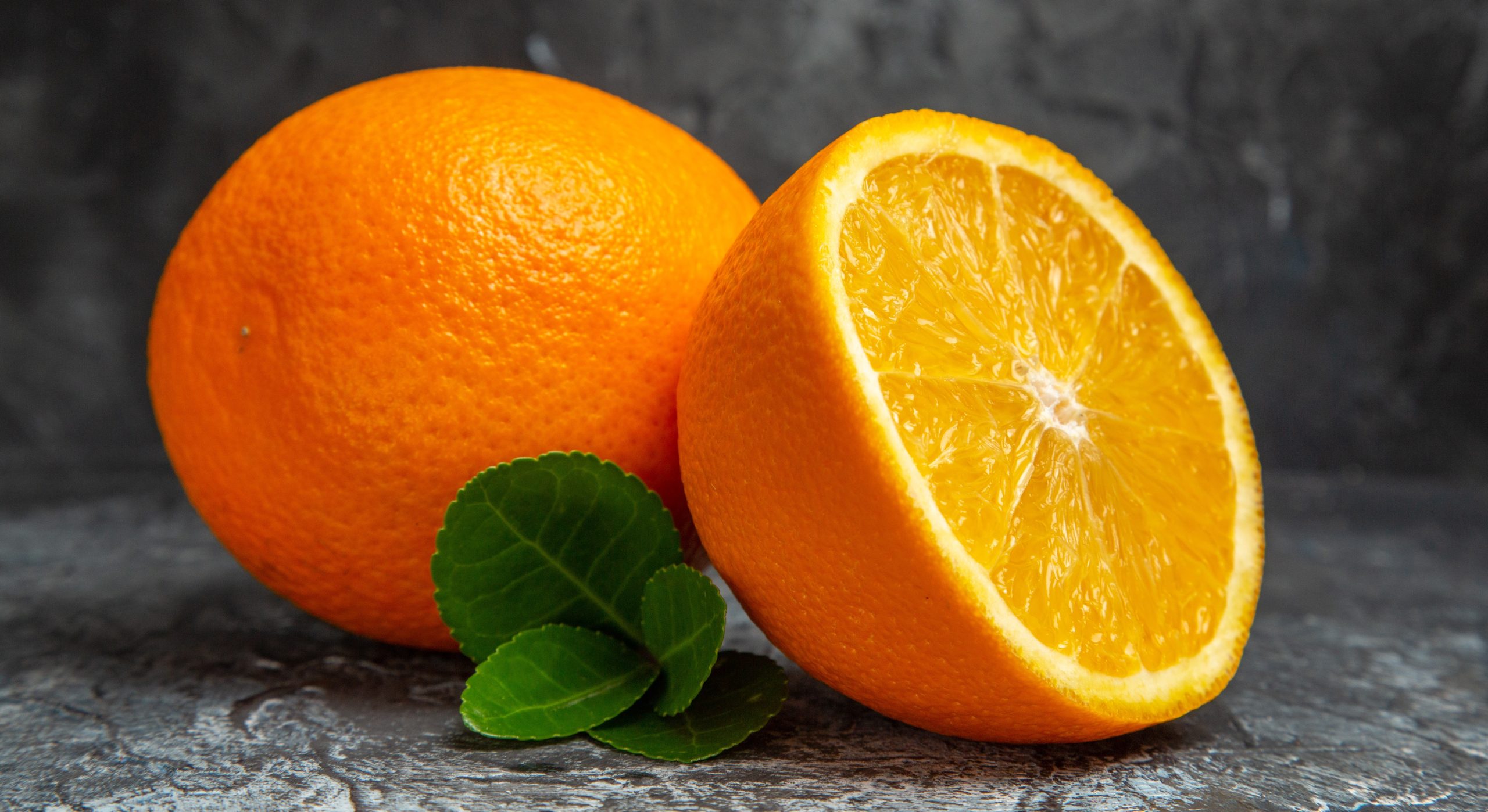 horizontal-view-whole-cut-half-fresh-oranges-gray-background